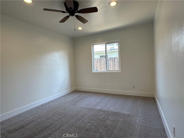 carpeted spare room featuring recessed lighting, baseboards, and ceiling fan