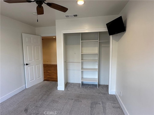 unfurnished bedroom featuring baseboards, visible vents, carpet floors, and a closet