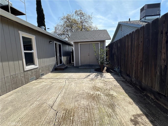 exterior space featuring a storage shed, an outdoor structure, and fence
