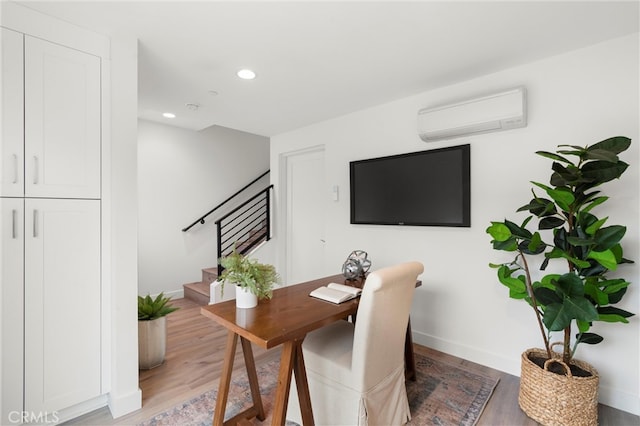 home office featuring recessed lighting, baseboards, light wood-style flooring, and a wall mounted AC