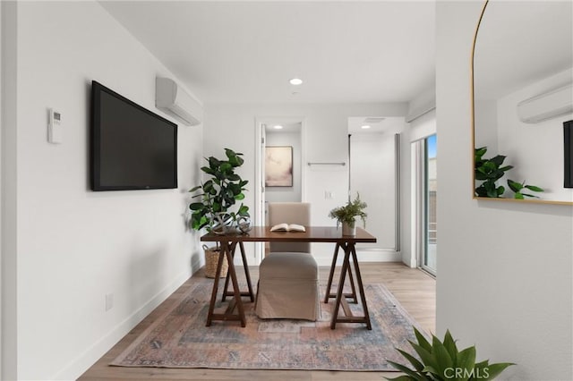 office area featuring recessed lighting, baseboards, wood finished floors, and a wall mounted AC