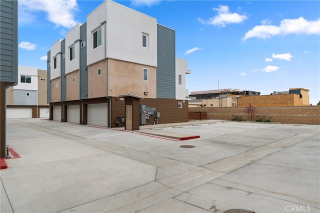 back of property with a residential view and stucco siding