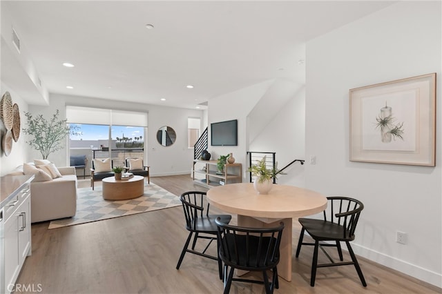 dining area featuring stairway, recessed lighting, light wood-style floors, and baseboards