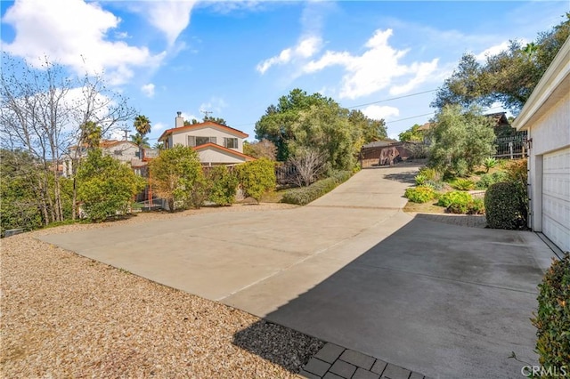 exterior space featuring a garage and fence