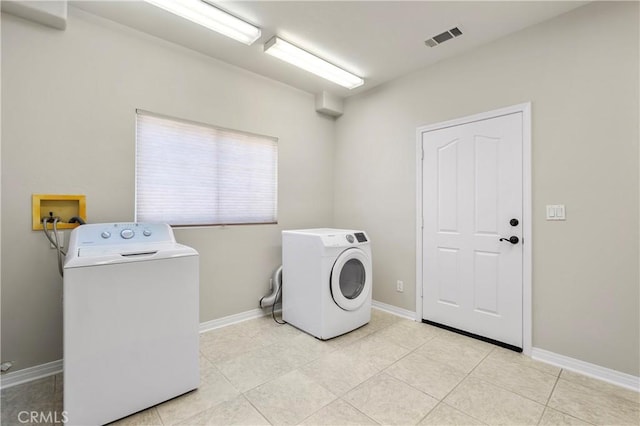 clothes washing area featuring visible vents, baseboards, independent washer and dryer, and laundry area