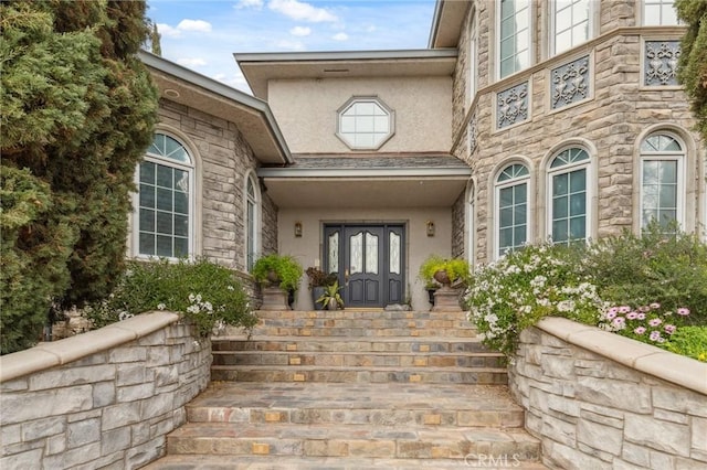 entrance to property featuring stucco siding