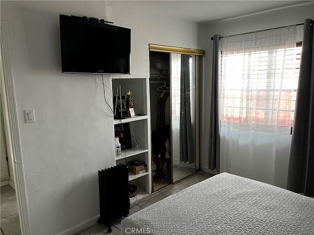 bedroom featuring tile patterned floors and a closet