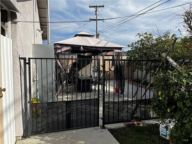 view of gate with a gazebo and fence