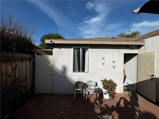 back of property featuring a patio, fence, and stucco siding