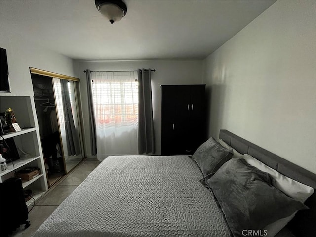 bedroom featuring light tile patterned floors and a closet