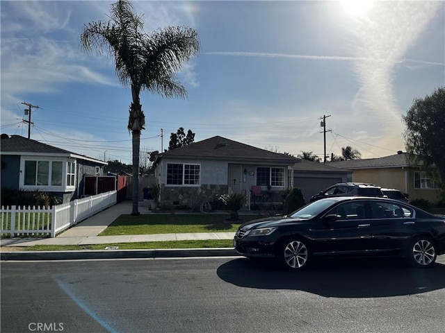 view of front of house with a front lawn and fence