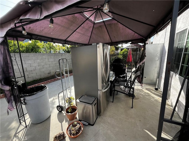 view of patio featuring a gazebo and fence