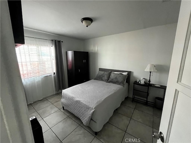 bedroom featuring light tile patterned flooring