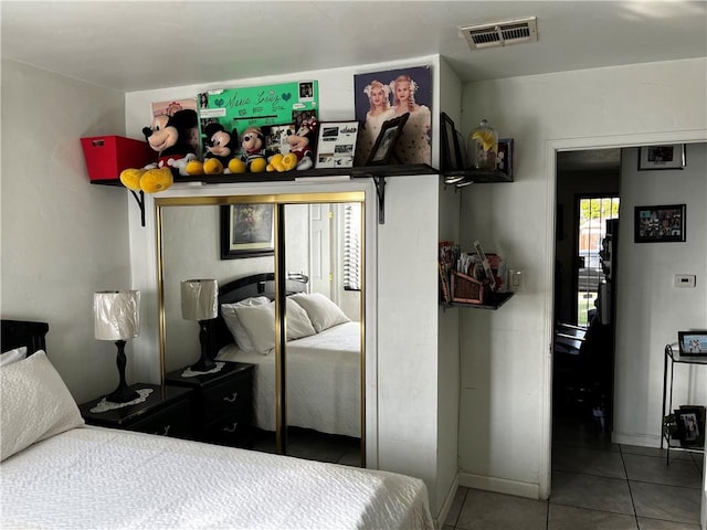 tiled bedroom featuring visible vents and baseboards