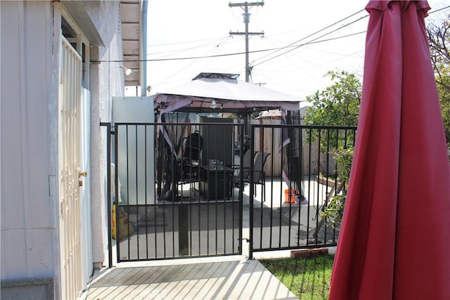 view of gate with a gazebo and fence