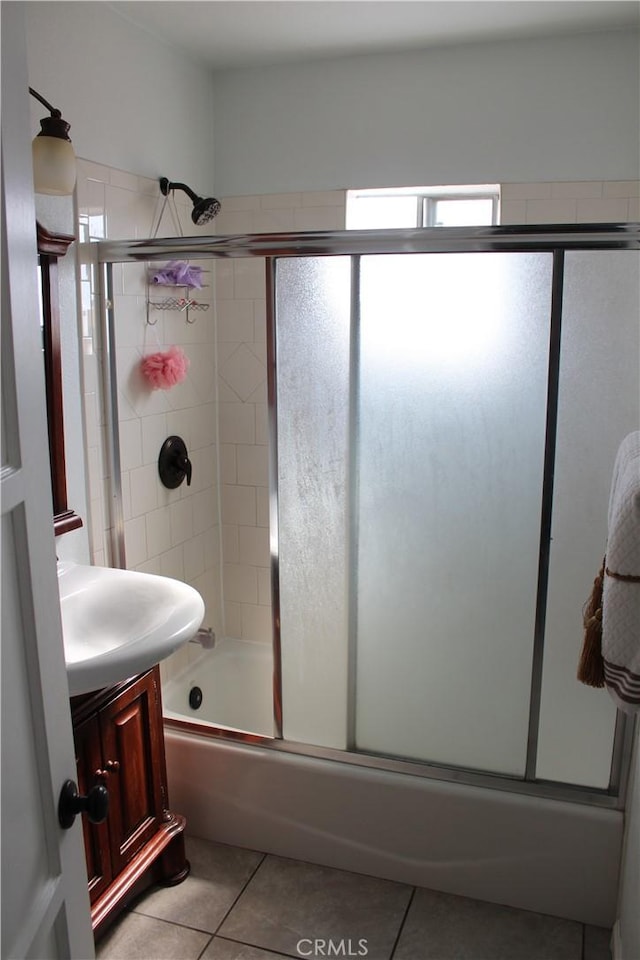 bathroom with tile patterned floors, combined bath / shower with glass door, and vanity
