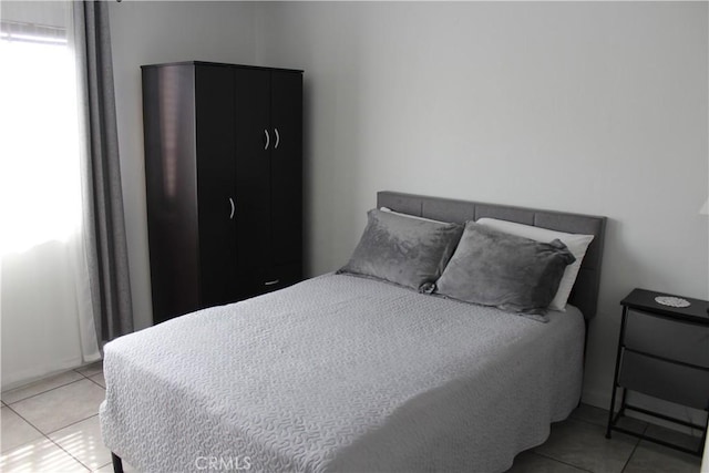bedroom featuring light tile patterned flooring