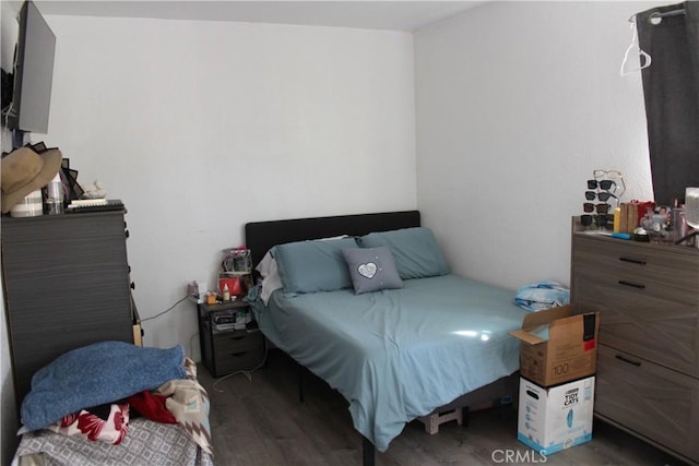 bedroom with wood finished floors