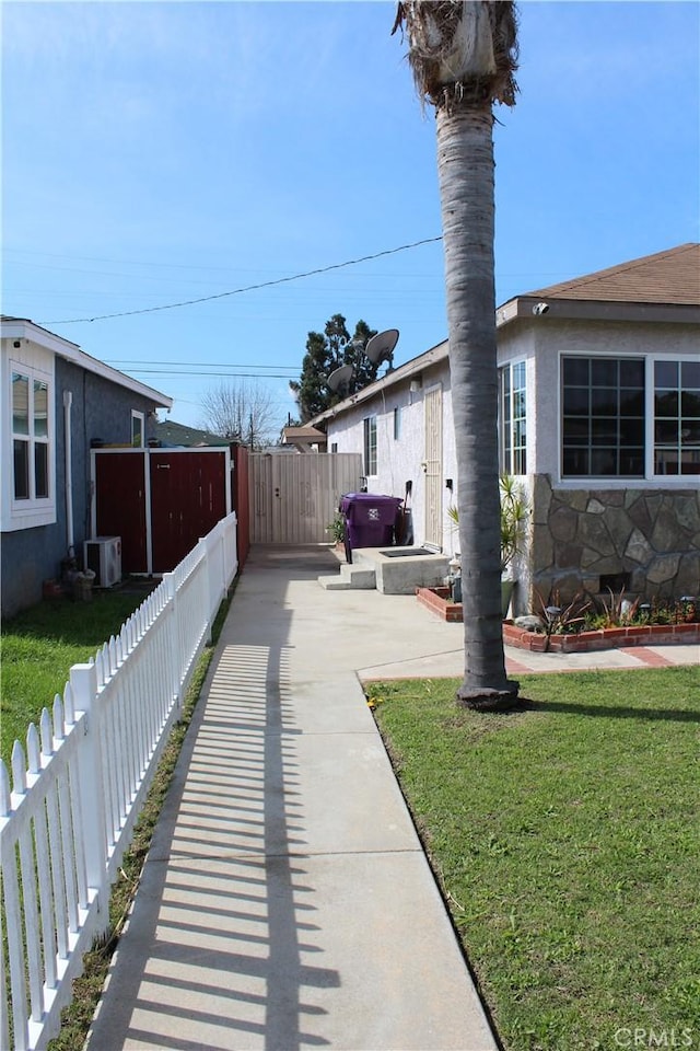 view of yard featuring ac unit and fence