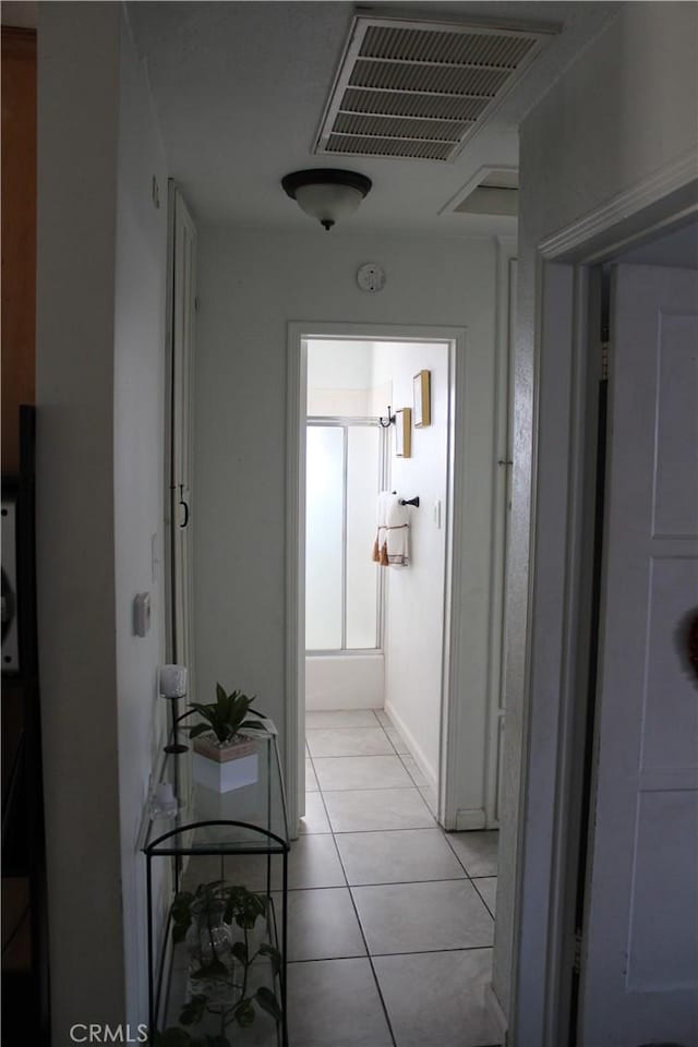 hallway with light tile patterned floors and visible vents
