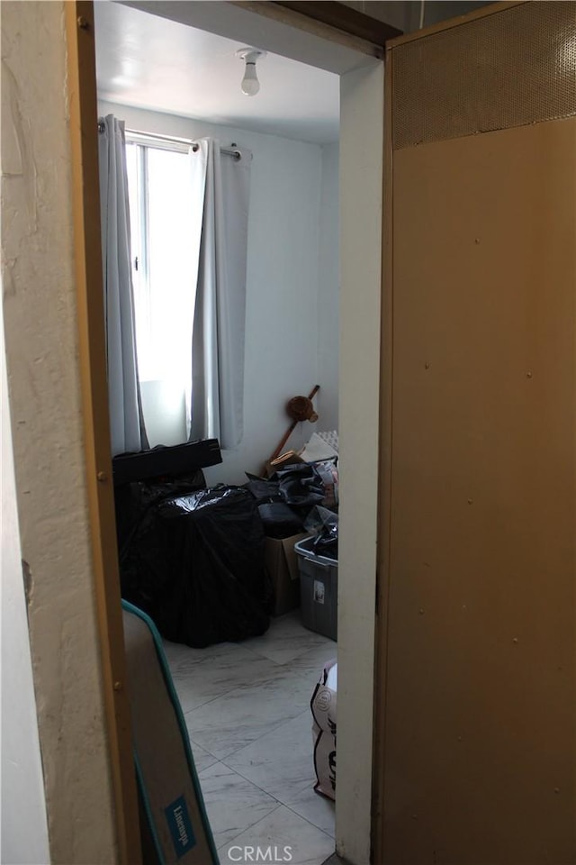 bedroom featuring marble finish floor