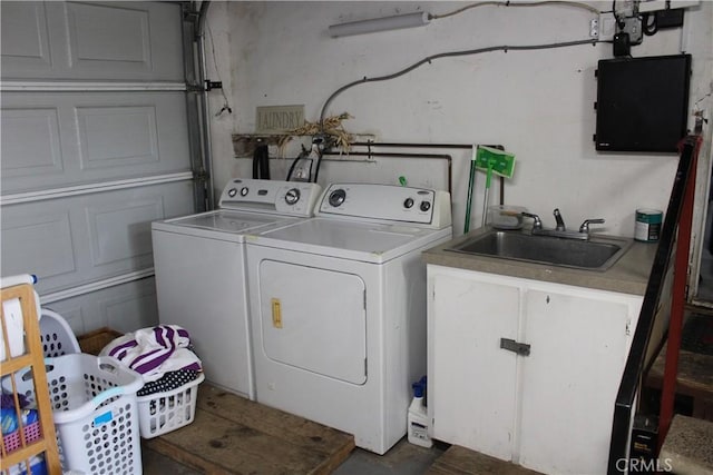 washroom with washing machine and clothes dryer and a sink