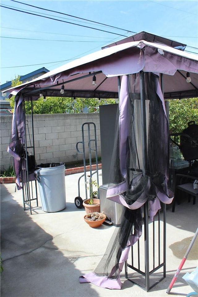 view of patio featuring fence