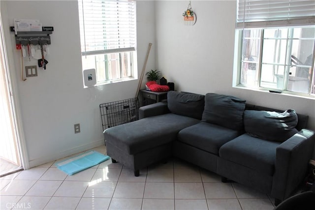 tiled living area featuring baseboards