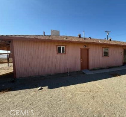 rear view of property featuring a carport