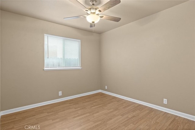 unfurnished room featuring baseboards, light wood-style floors, and a ceiling fan