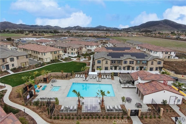 exterior space with a mountain view, a patio, a residential view, and fence