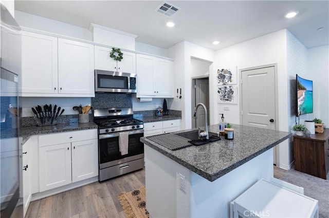 kitchen featuring visible vents, recessed lighting, appliances with stainless steel finishes, light wood-style floors, and white cabinetry