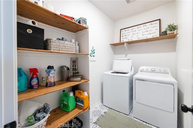 laundry room with laundry area, washing machine and dryer, and baseboards