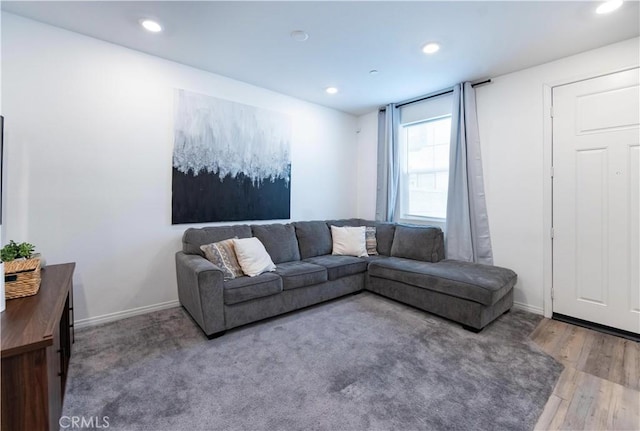 living area featuring recessed lighting, baseboards, and wood finished floors