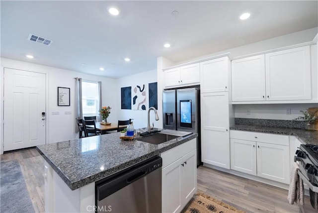 kitchen featuring visible vents, a sink, black range with gas cooktop, dishwasher, and light wood-type flooring