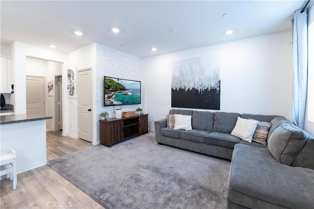 living area with recessed lighting and light wood-style floors