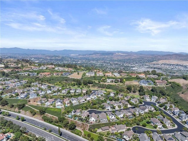 drone / aerial view featuring a residential view and a mountain view