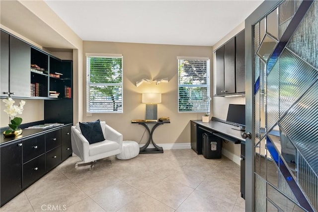 office area featuring light tile patterned flooring and baseboards