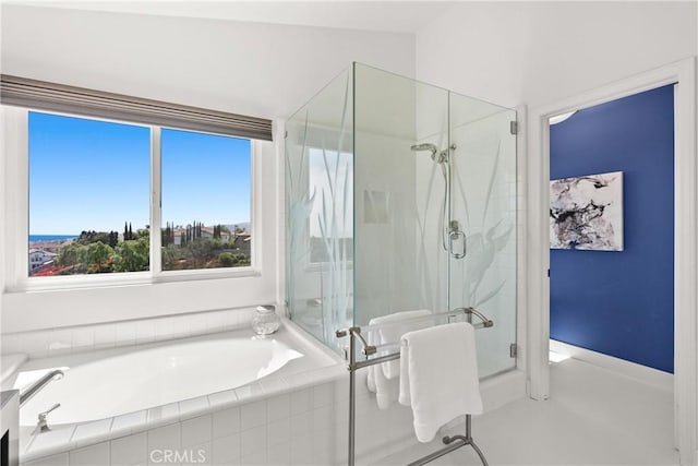 bathroom featuring a garden tub, a stall shower, and vaulted ceiling