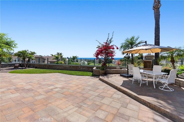 view of patio / terrace featuring outdoor dining area and fence