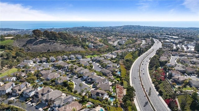 birds eye view of property with a residential view and a water view