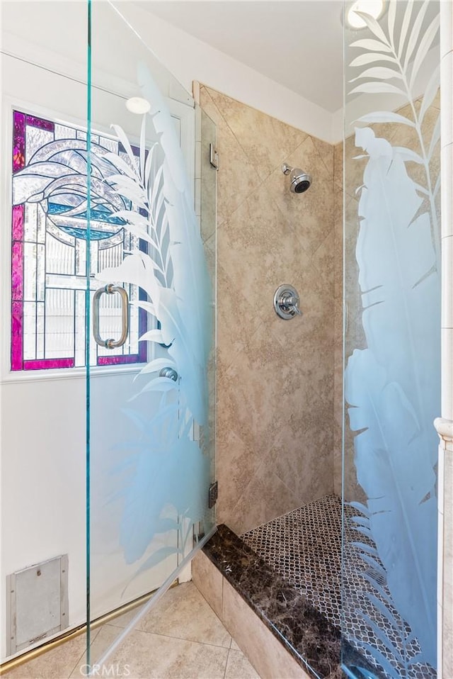 bathroom featuring tile patterned floors and a shower stall