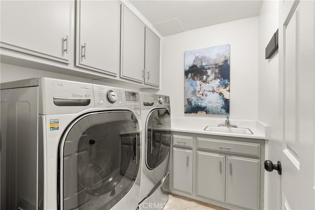 laundry room featuring a sink, cabinet space, independent washer and dryer, and light tile patterned floors