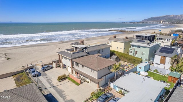 birds eye view of property featuring a beach view and a water view