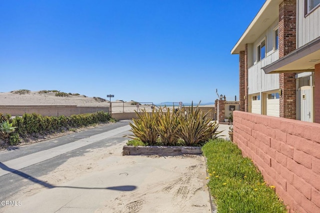 exterior space with a garage and fence