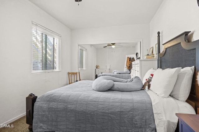 carpeted bedroom with baseboards and a ceiling fan