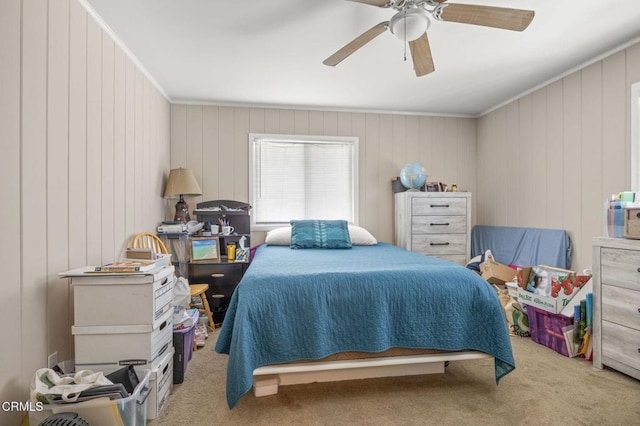 bedroom featuring a ceiling fan, carpet, and ornamental molding