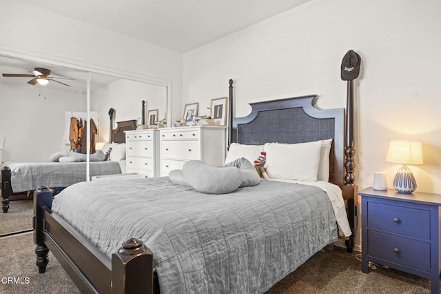 bedroom featuring a closet and dark colored carpet