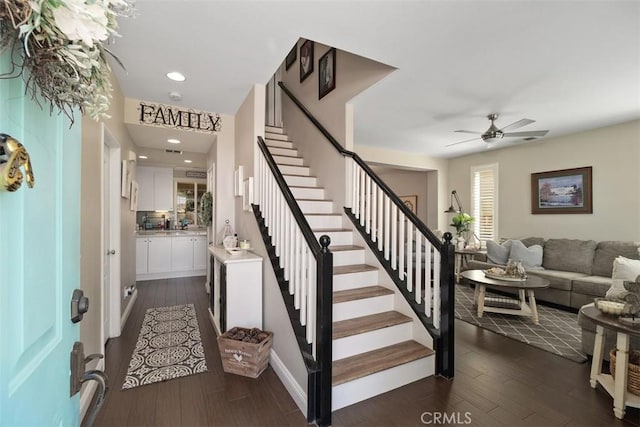 foyer featuring recessed lighting, dark wood-style flooring, and stairs