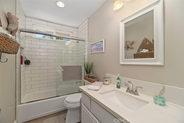 full bathroom featuring enclosed tub / shower combo, toilet, vanity, and wood finished floors